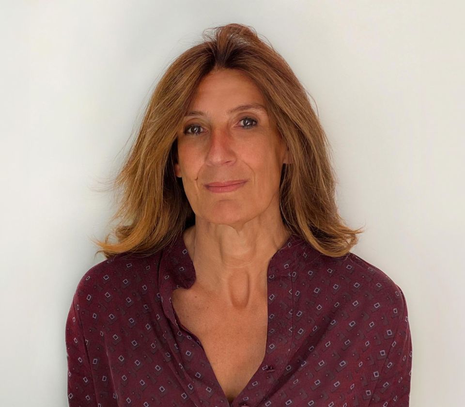 Portrait of Nathalie Lameyre, standing in a bright room