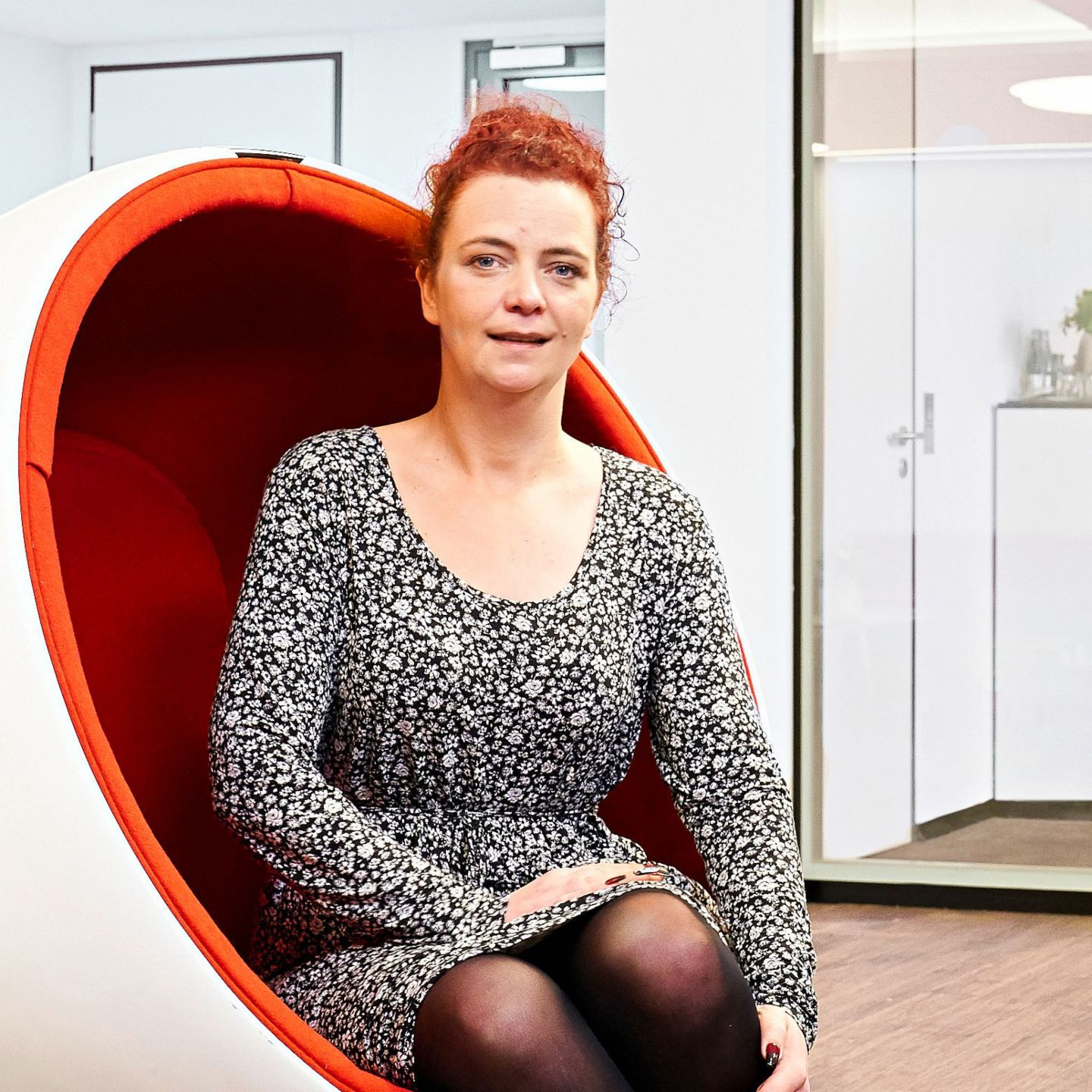 Interview: Call center agent Katja Wolf sitting in an armchair.