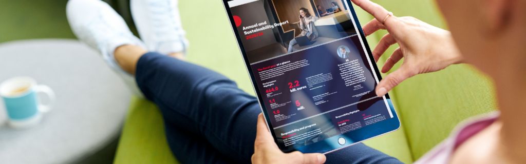 The image shows a young woman holding a tablet and looking at the EOS Annual Sustainability Report on it.