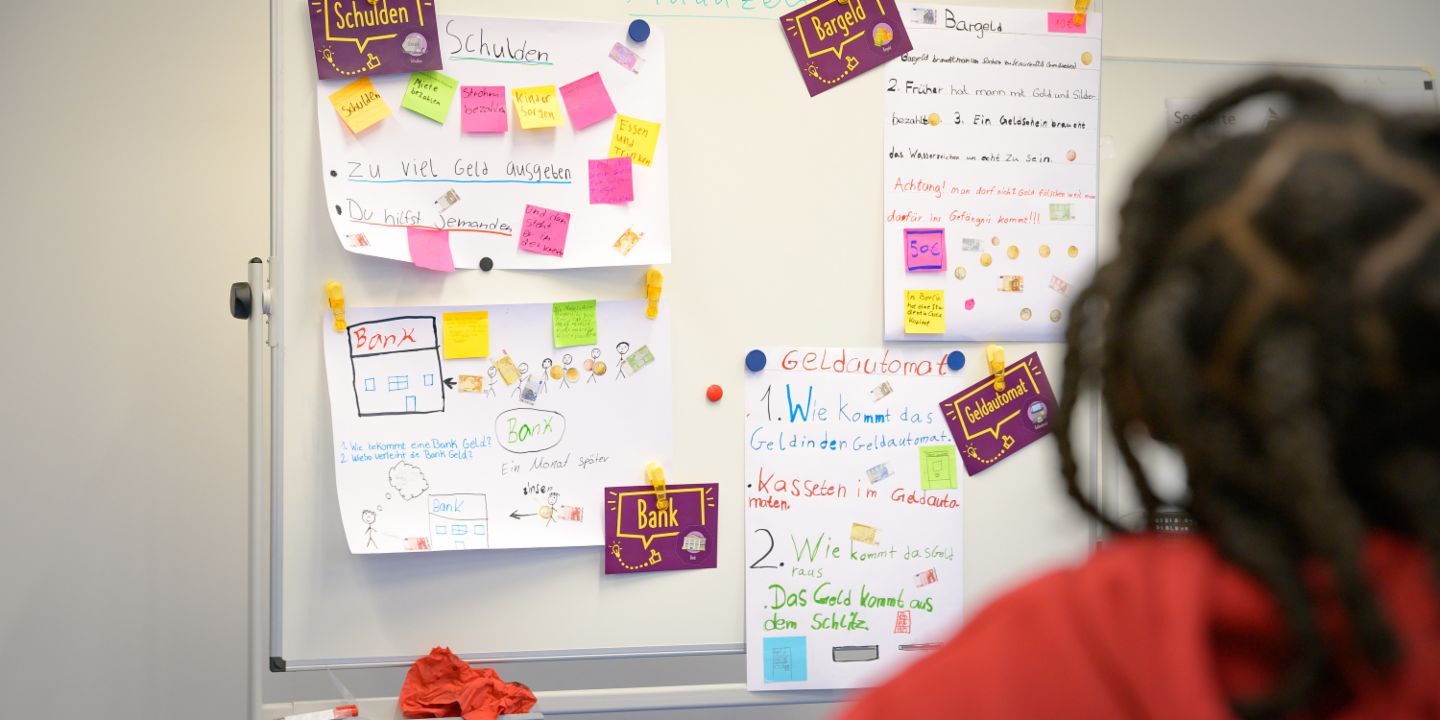 Financial education for children: A schoolgirl looks at her budget.