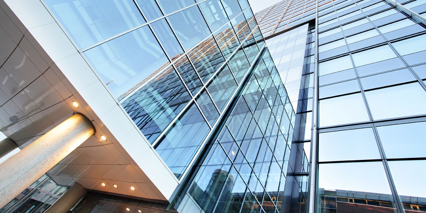 The sale of non-performing real estate portfolios: People standing in the entrance of an office building.