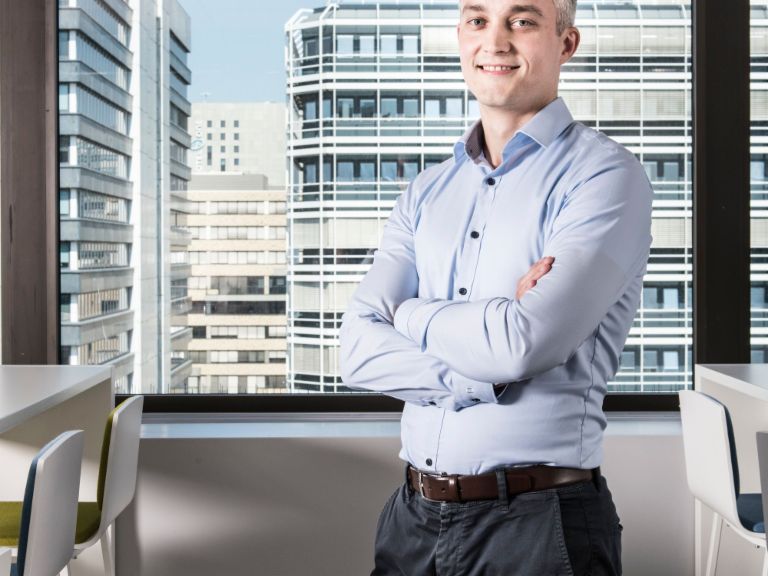 Andreas Dix from the EOS Data Science Team sitting in front of the window in an office