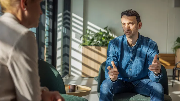Two EOS employees in a conversation about sustainable actions and environmental responsibility in the office